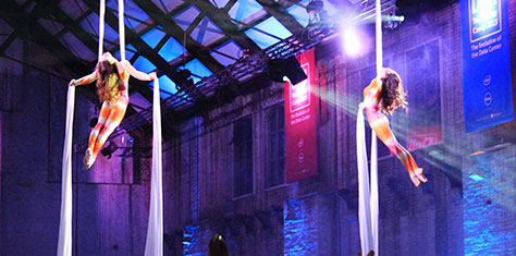 Acrobatics performing aerial acts with silks